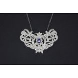 A white metal (tested high carat gold) necklace set with an oval cut sapphire and brilliant cut