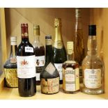 A group of eight bottles of vintage wines and liquors.