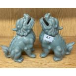 A pair of Chinese celadon crackle glazed pottery figures of lion dogs, H. 19cm.