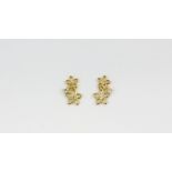 A pair of 14ct yellow gold (stamped 14K) flower shaped diamond set stud earrings, approx. L. 1cm.