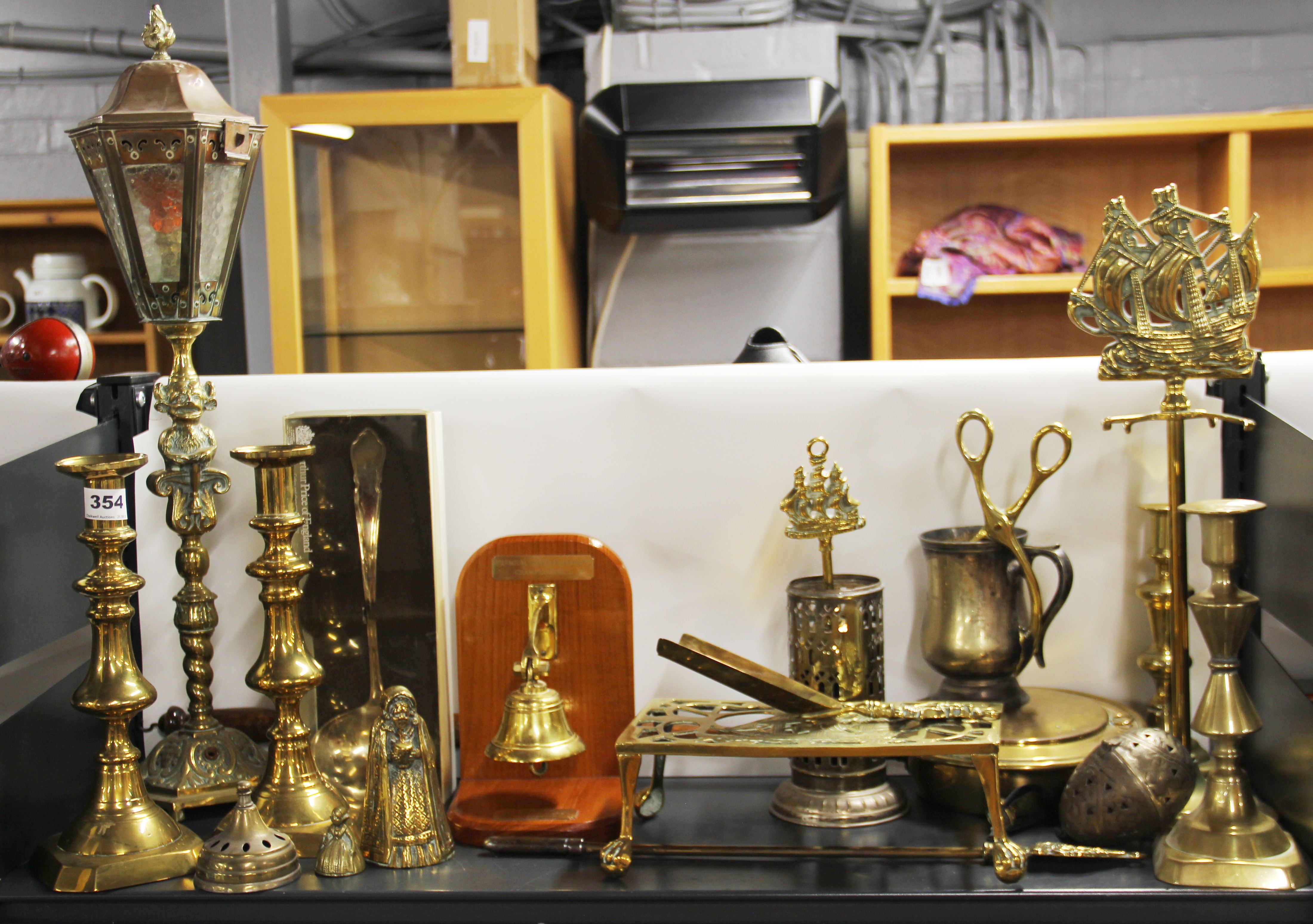 A 1920's brass table lamp, H. 61cm. Together with Victorian brass candlesticks and other items.