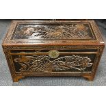 A vintage Chinese carved camphor wood lined trunk, 101 x 51 x 59cm.