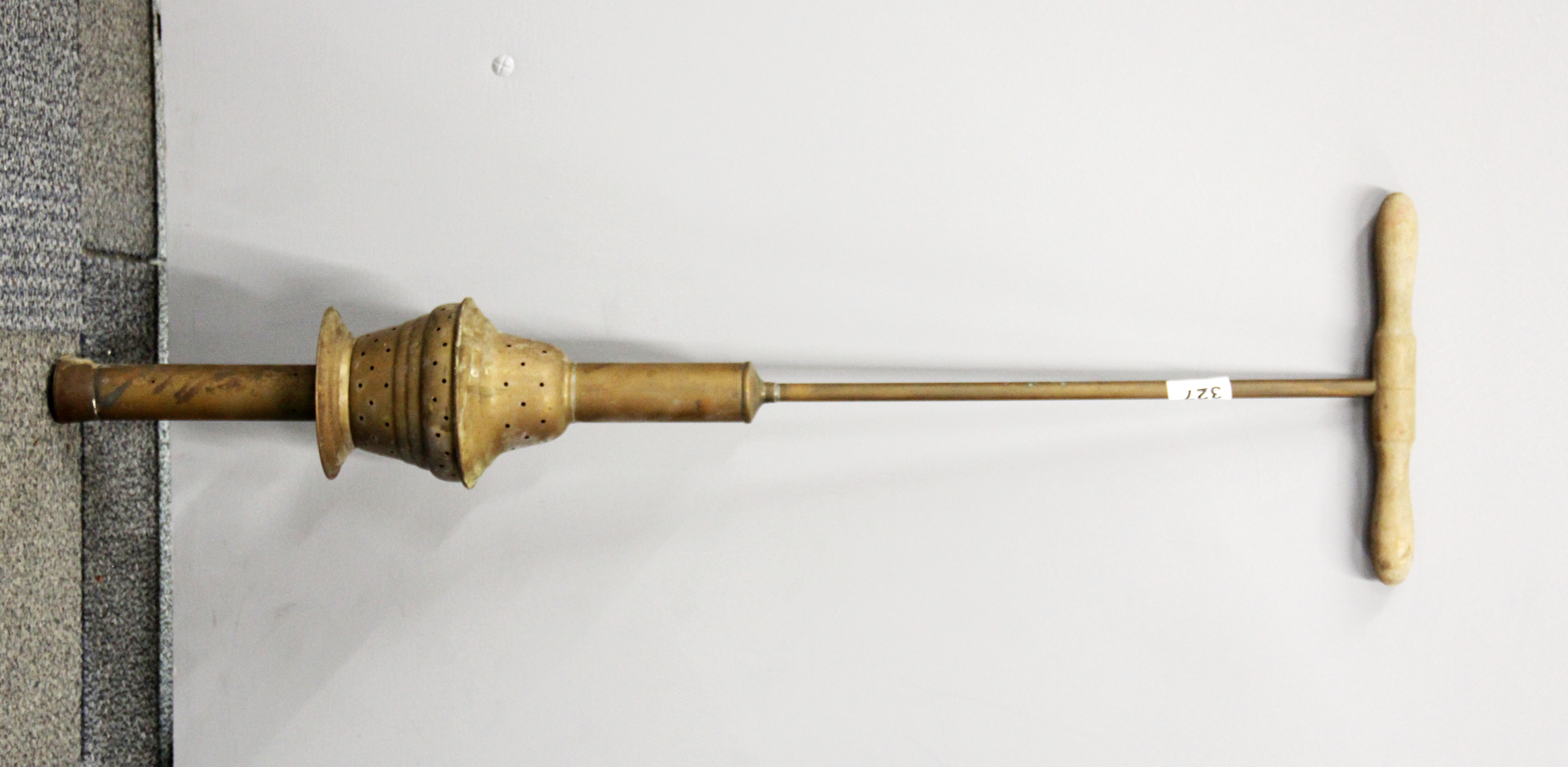 An early spring action wood and brass posser, L. 86cm.