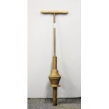 An early spring action wood and brass posser, L. 86cm.