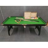 A foldaway half sized snooker table, 191 x 100cm, with balls, cues and scorer.