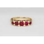 An Edwardian yellow metal (tested 15ct gold) ring set with rubies and rose cut diamonds, (L.5).