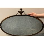 A 1920's bronzed finished metal framed oval wall mirror, 73 x 53cm.