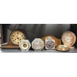 A group of vintage clocks and a barometer.