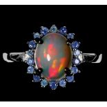A 925 silver cluster ring set with cabochon cut opal surrounded by sapphires, (Q).