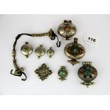 A group of Tibetan white metal ga'u, some set with semi precious stones, largest W. 7cm.