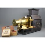 A Victorian Husband and sons brass and tin magic lantern projector with some lantern slides.