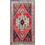 An antique Eastern hand woven wool rug, 193 x 135cm.