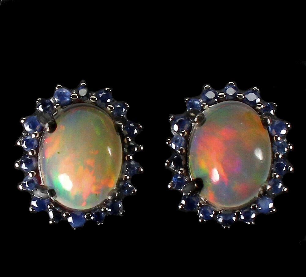 A pair of 925 silver cluster earrings set with cabochon cut opals surrounded by sapphires, L. 1.