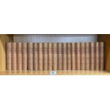 Twenty volumes of tan clothbound works by Charles Dickens published by Cassell and Company,