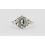A platinum (stamped Plat) ring set with an emerald cut aquamarine and diamond set ring, (P).