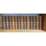 Thirteen volumes of half leather bound works by William Makepeace Thackery, published by the