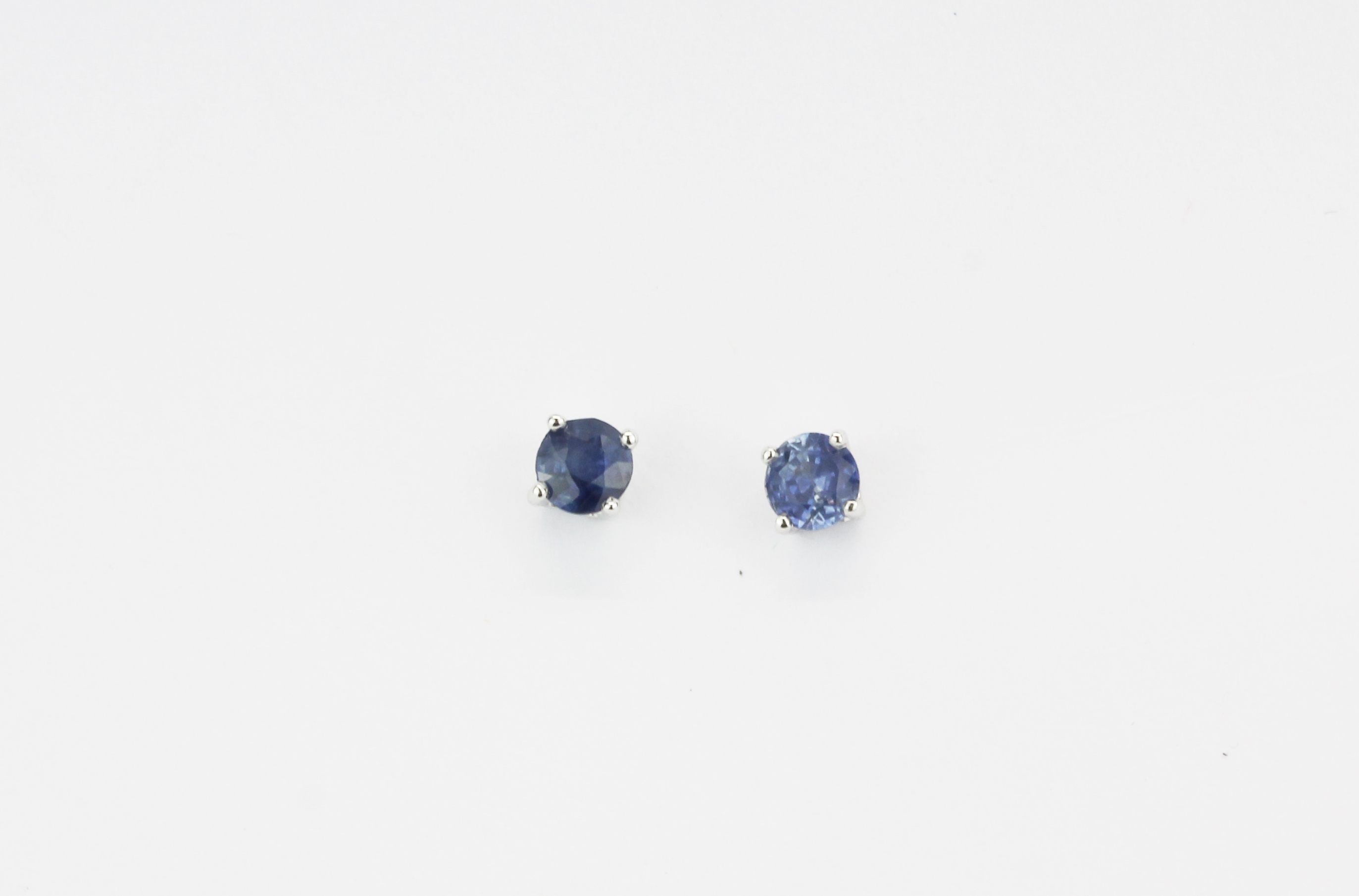 A pair of 9ct white gold (stamped 9K) stud earrings set with brilliant cut sapphires, approx. L.