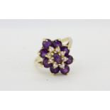 A 14ct yellow gold cluster ring set with amethysts and seed pearls, (P).