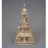 A Tibetan silvered bronze model of a Stupa with removable lid for offerings, H. 19cm.
