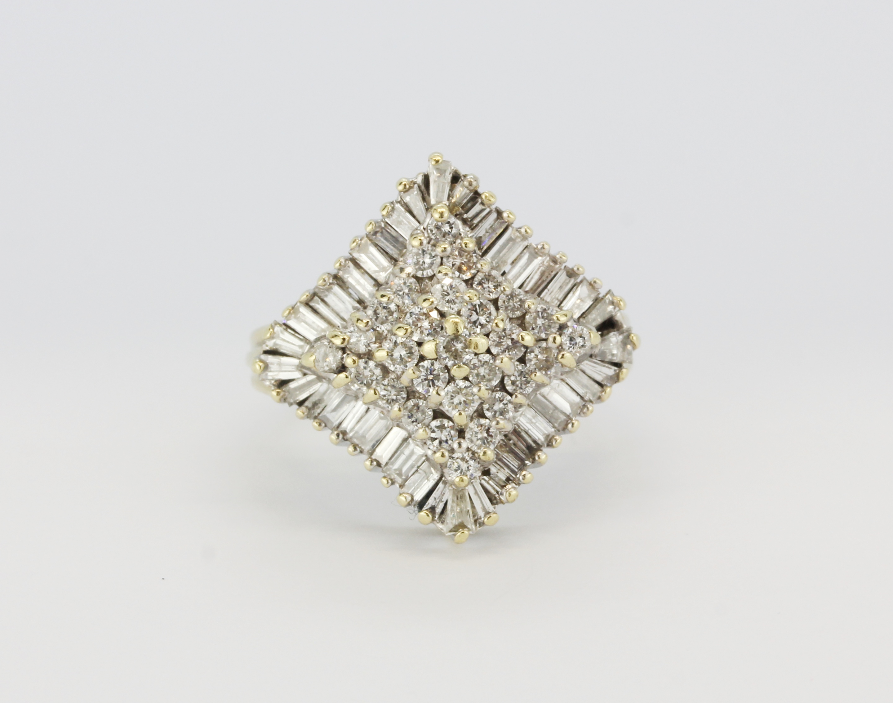 A very large yellow and white metal (tested 18ct gold) cluster ring set with baguette cut and