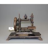 A Victorian miniature sewing machine, H. 21cm.