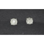 A pair of 9ct white gold diamond set stud earrings, Dia. 0.6cm.