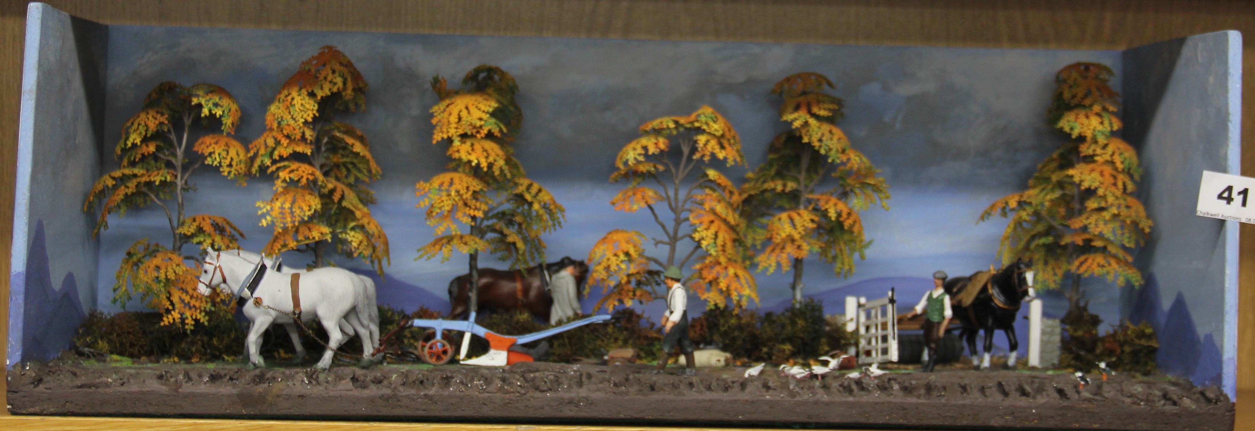 An interesting tableau of a farming scene made with hand painted metal figures, W. 57 x 21cm.