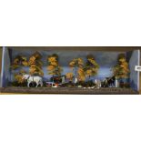 An interesting tableau of a farming scene made with hand painted metal figures, W. 57 x 21cm.