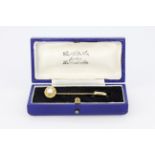 A boxed antique yellow metal (tested minimum 9ct gold) stick pin set with a cultured pearl