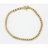 A yellow metal (tested minimum 9ct gold) diamond set bracelet, approx. L. 19cm.