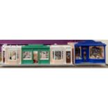 A handmade row of dolls house scale shops, W. 153cm. H. 36cm. With contents.