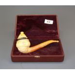 A rare meerschaum carved smoking pipe by 'artist Ismail Ozel' with erotic scenes visible through a