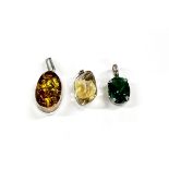 A silver and amber pendant together with a white metal and citrine pendant and a white metal and