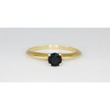 A 9ct yellow gold sapphire set solitaire ring, (Q.5).