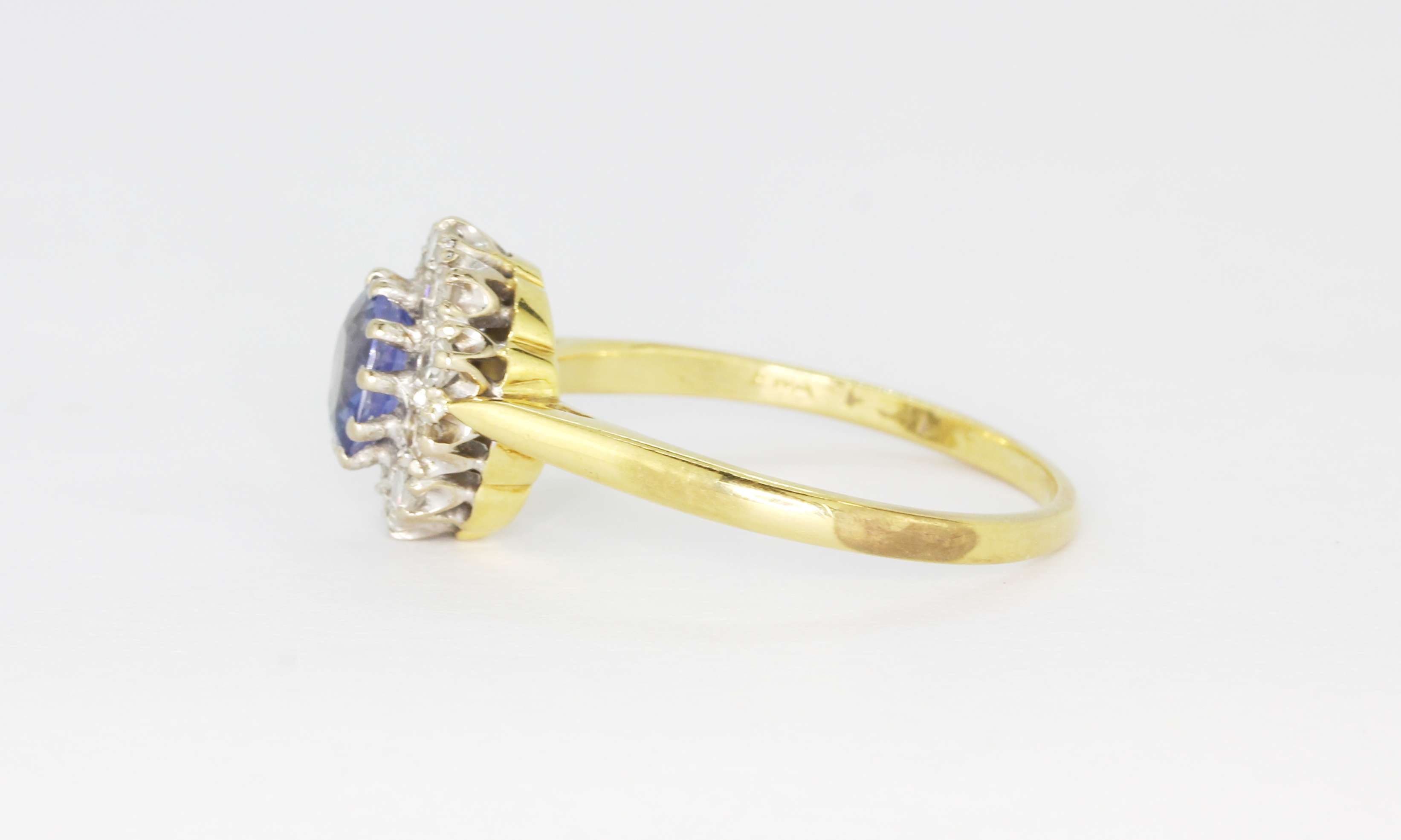 An 18ct yellow and white gold cluster ring set with an oval cut cornflower sapphire surrounded by - Bild 2 aus 3