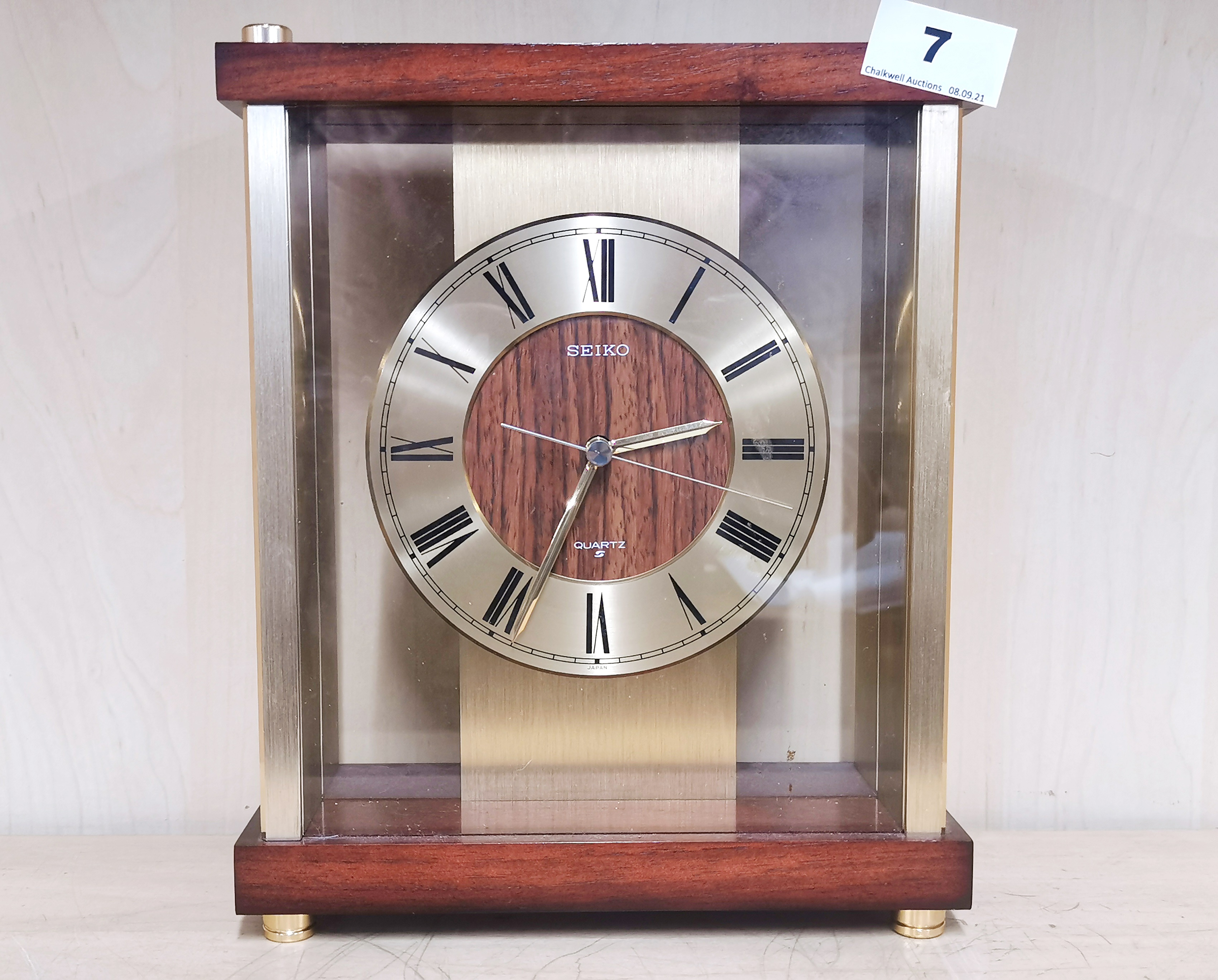 A 1970's Seiko gilt brass and teak mantle clock, H. 25cm. Currently in working order.