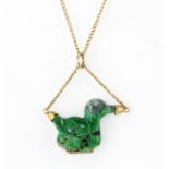 A 9ct yellow gold necklace set with a carved jade/hardstone duck shaped pendant.