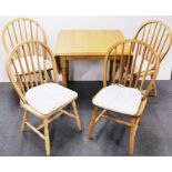 A useful heavy quality drop leaf kitchen table and four chairs, 75 x 75cm. Opening to 115cm.