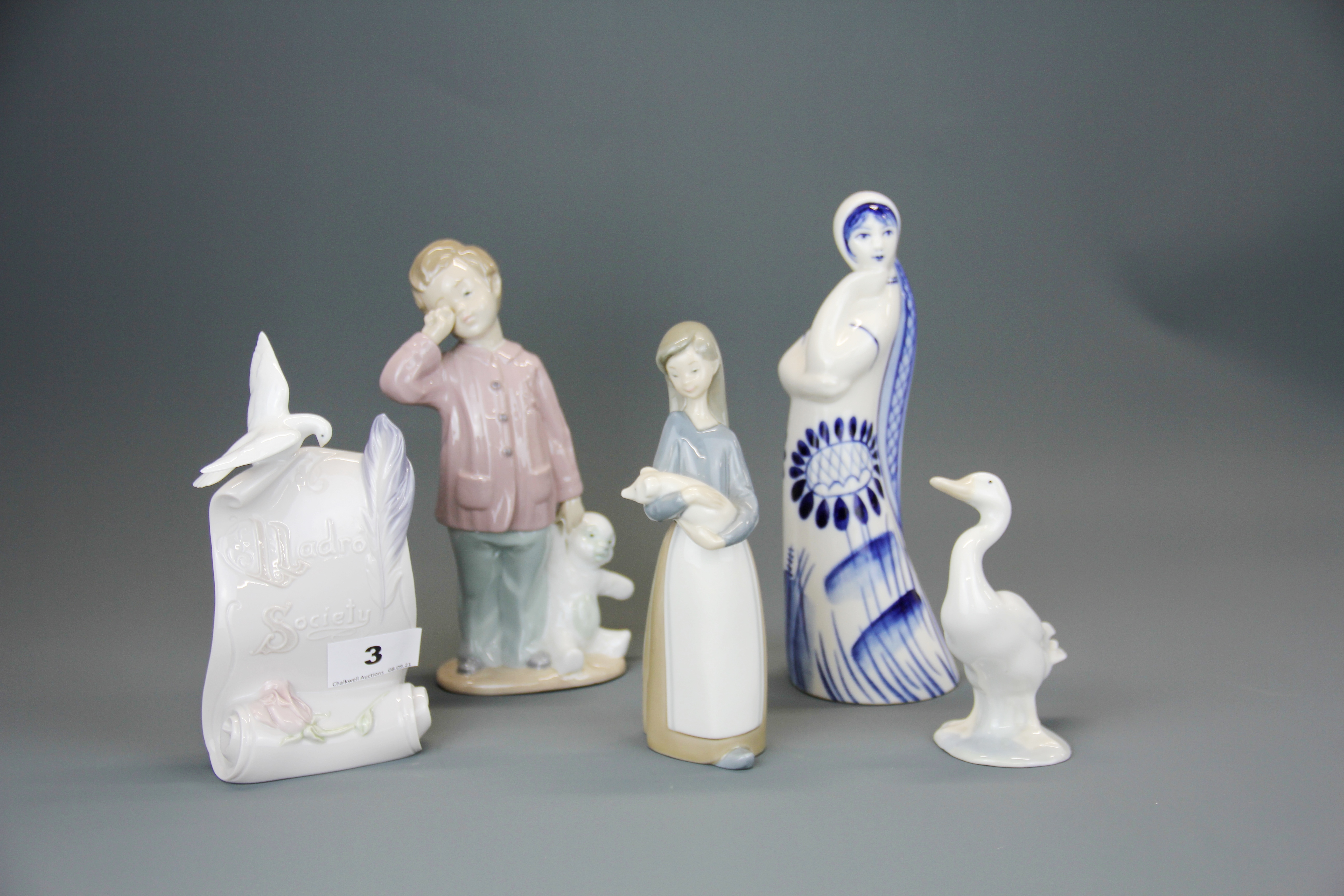 Three Lladro items, tallest 17cm. together with a Nao figure of a boy and a Russian porcelain