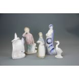 Three Lladro items, tallest 17cm. together with a Nao figure of a boy and a Russian porcelain