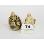 Two miniature porcelain doll figures, one encased in a shell as a pin cushion, H. 6cm.