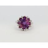 A 10ct white gold (stamped 10k) ring set with a large fancy cut amethyst and brilliant cut diamonds,