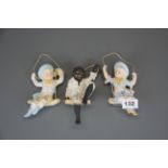 Three Victorian porcelain swinging figures, H. 14cm. Black figure is A/F.