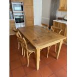 A contemporary solid oak kitchen table and four chairs, 90 x 150cm.