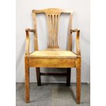 An 18th C oak rush seat arm chair.