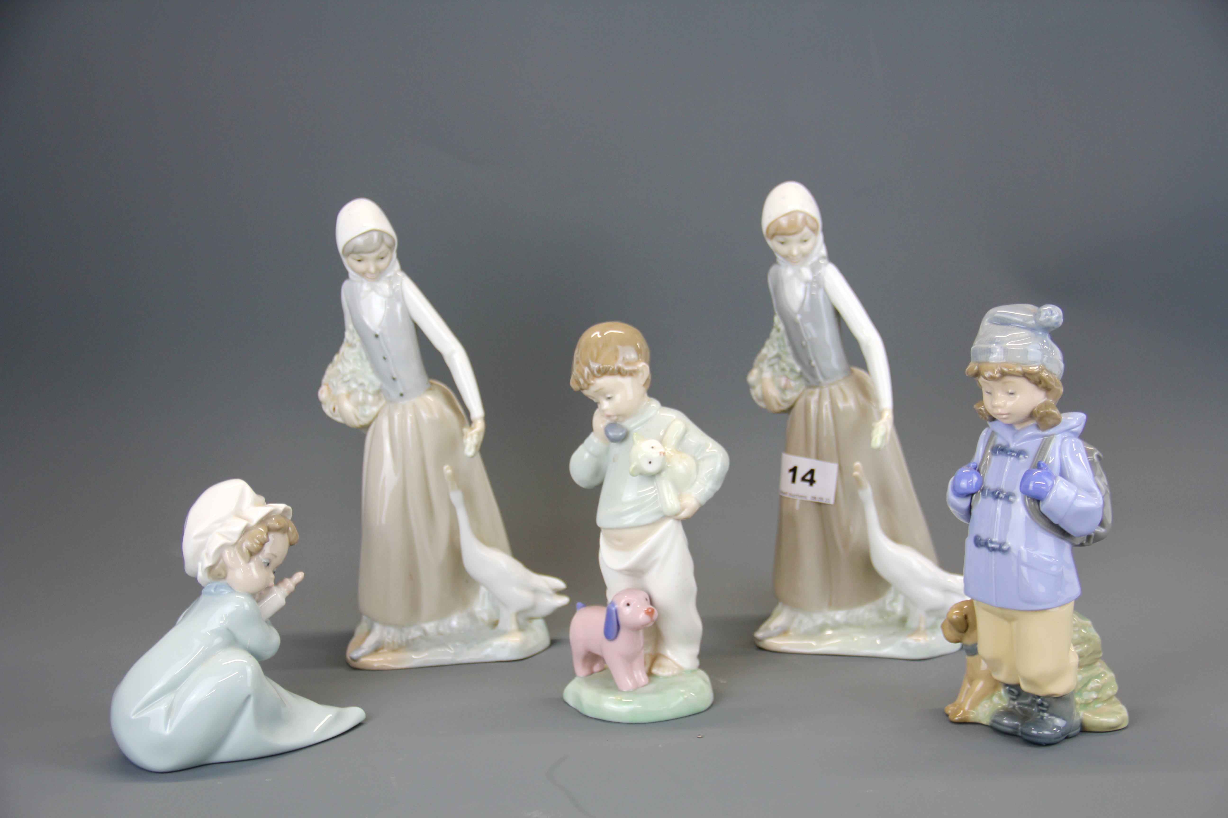 A group of five Nao porcelain figurines, tallest 24cm.