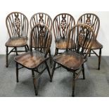 A set of six wheel back country chairs.
