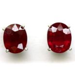 A pair of 925 silver stud earrings set with large oval cut rubies, L. 1cm.