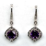 A pair of 925 sivler drop earrings set with amethysts and white stones, L. 3.2cm.