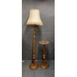 An oriental carved teak standard lamp and matching plant stand.